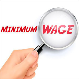 A magnifying glass enlarges the red text “MINIMUM WAGE- Moss Bollinger LLP
