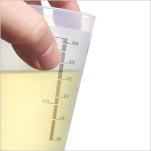 A person holding a measuring cup filled with liquid- Moss Bollinger LLP