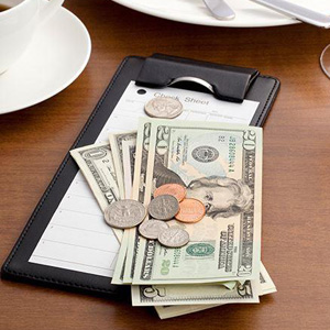 A clipboard with dollar bills attached- Moss Bollinger LLP