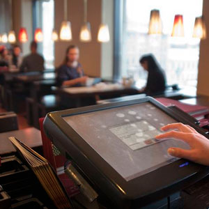 A person using a tablet at a restaurant- Moss Bollinger LLP