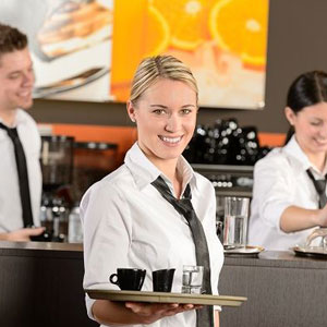A waitress holding a tray with coffee and food, ready to serve customers in a restaurant- Moss Bollinger LLP