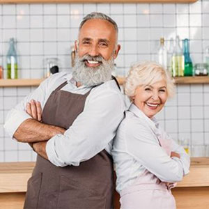 A happy couple posing in front of a bar, radiating joy and contentment- Moss Bollinger LLP