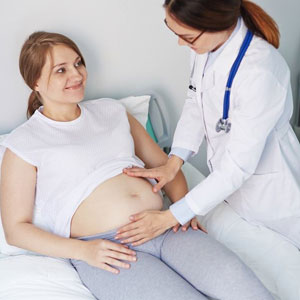 A doctor examining a pregnant woman to ensure her health and well-being during this crucial time- Moss Bollinger LLP