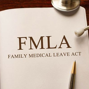 A medical document titled “FMLA FAMILY MEDICAL LEAVE ACT” with stethoscope and pen- Moss Bollinger LLP
