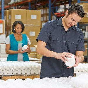 A man and woman collaborating in a warehouse, engaged in productive work- Moss Bollinger LLP
