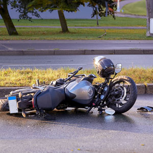 A motorcycle lying on the ground after an accident - Moss Bollinger LLP