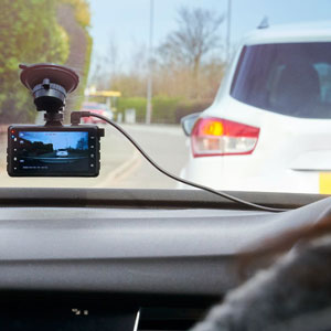A dash camera mounted on the windshield of a car - Moss Bollinger LLP