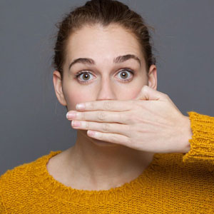 A woman in shock,her hands covering her mouth in surprise - Moss Bollinger LLP