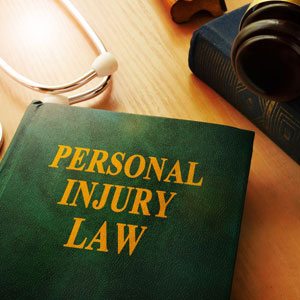 A personal injury law book and stethoscope laid out on a table - Moss Bollinger LLP