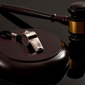 A judge's gavel and whistle on a black background - Moss Bollinger LLP