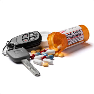 A prescription bottle, car keys, and pills arranged on a surface - Moss Bollinger LLP