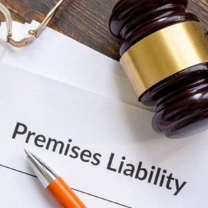A gavel and pen on paper with the words Premises Liability - Moss Bollinger LLP