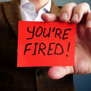 A man holding a red note with the word you're fired representing wrongful termination - Moss Bollinger LLP