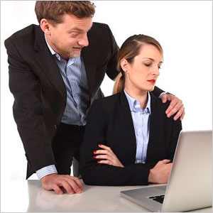 A man and woman in the office focused on a laptop - Moss Bollinger LLP