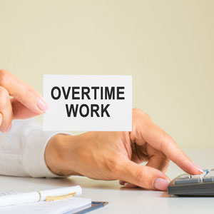 Conceptual image of overtime work, featuring a stock photo. - Moss Bollinger LLP
